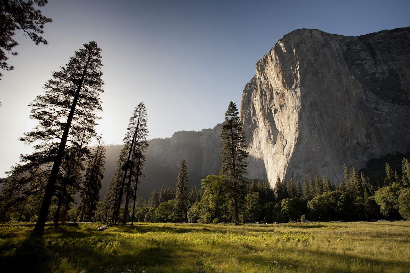 Tall granite cliffs rising above a valley